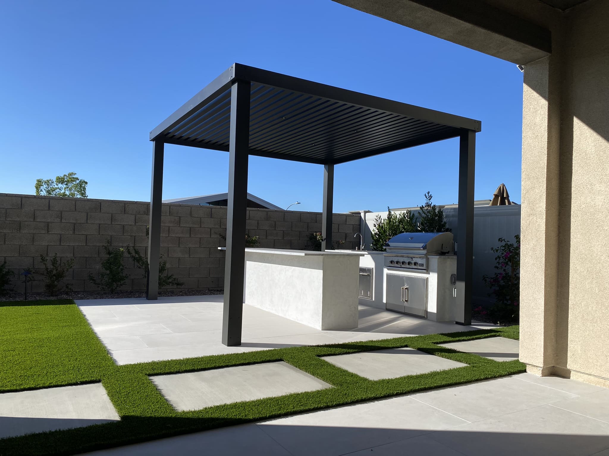 Modern aluminum pergola and patio cover by Abshire Brothers Lawn & Landscape Rayne