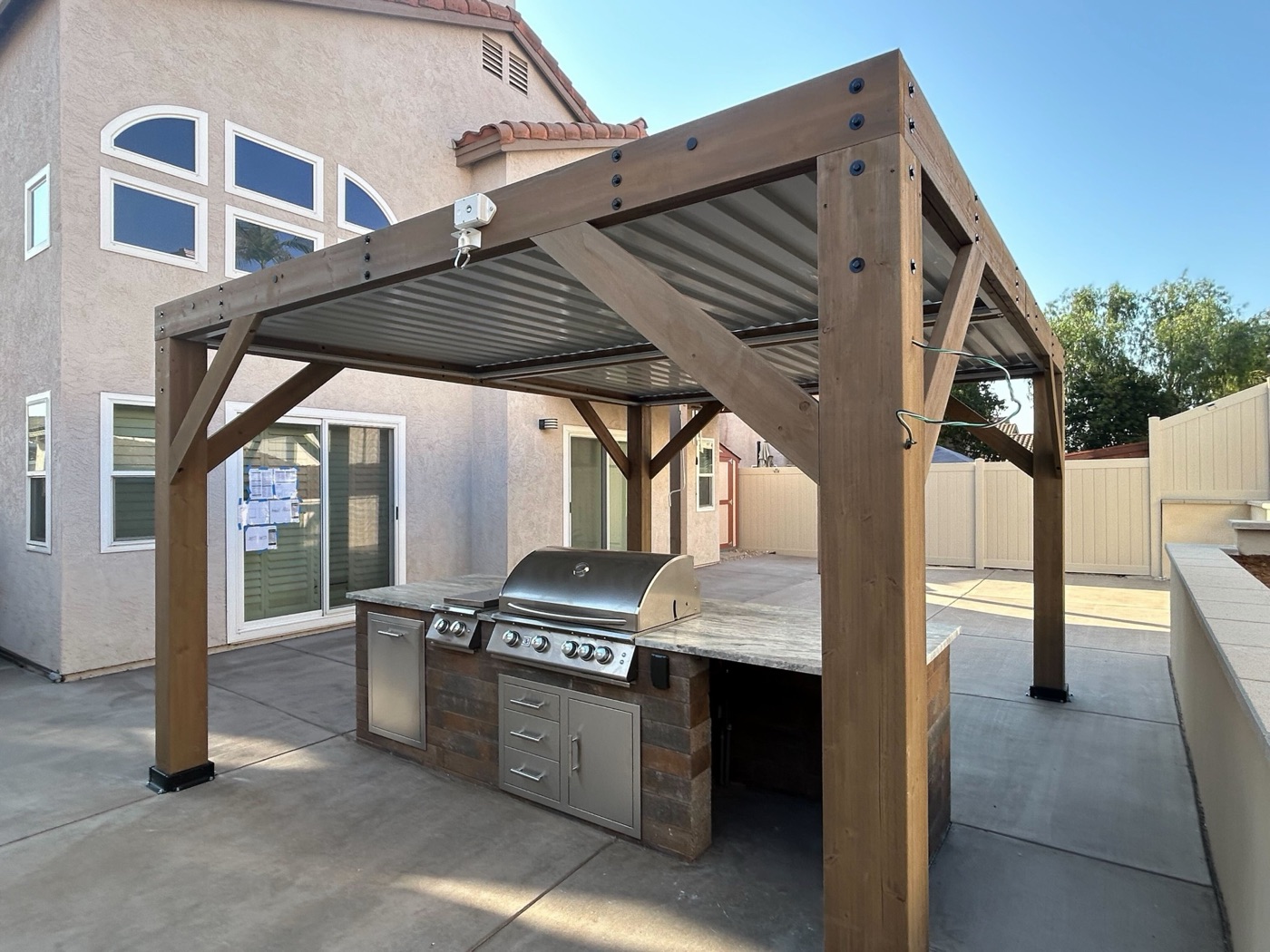 Cedar pergola over an outdoor kitchen in Kaplan by Abshire Brothers Lawn & Landscape